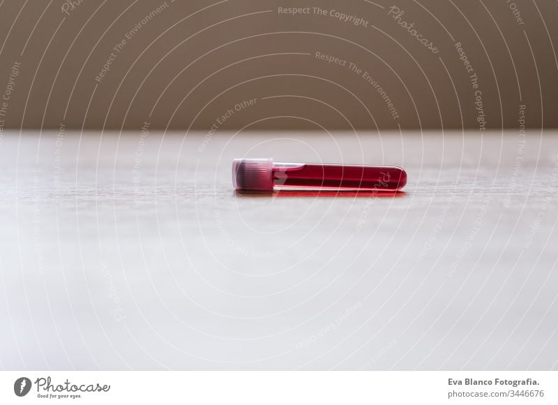 close up view of blood test tube. coronavirus covid 2019 and medicina concept nobody hand unrecognizable holding sample glasses experiment sterile fluid