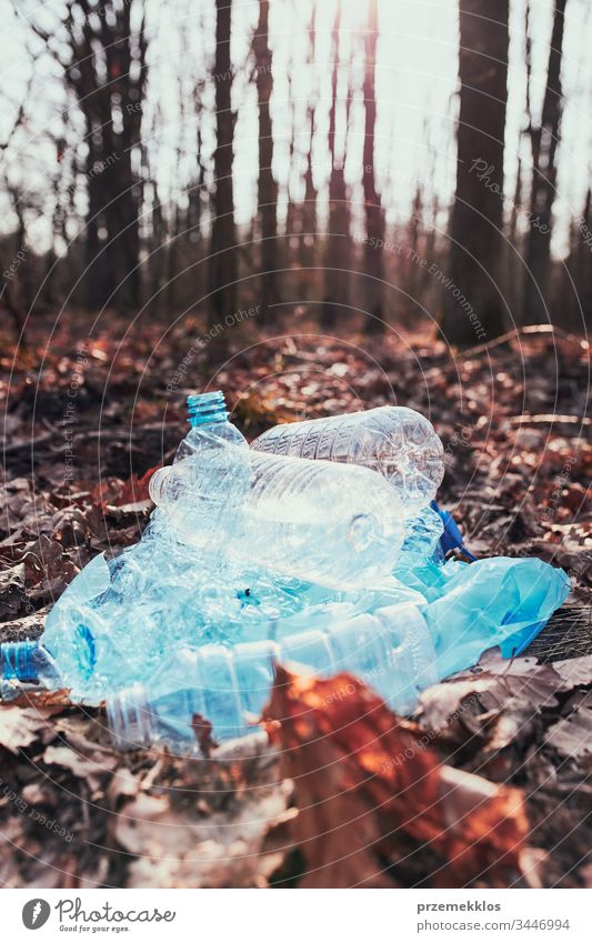 Plastic waste left in forest. Concept of plastic pollution and irresponsibility for environment. Environmental issue. Environmental damage. Real people, authentic situations