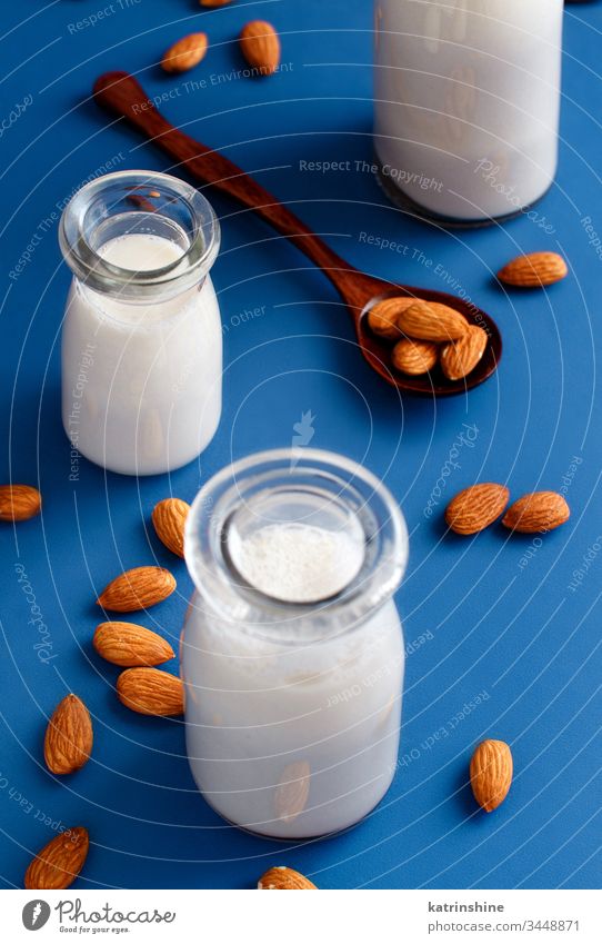 Vegan almond milk, non dairy alternative milk almonds beverage vegan classic blue bottle breakfast diet drink minimal negative space copy space food fresh glass