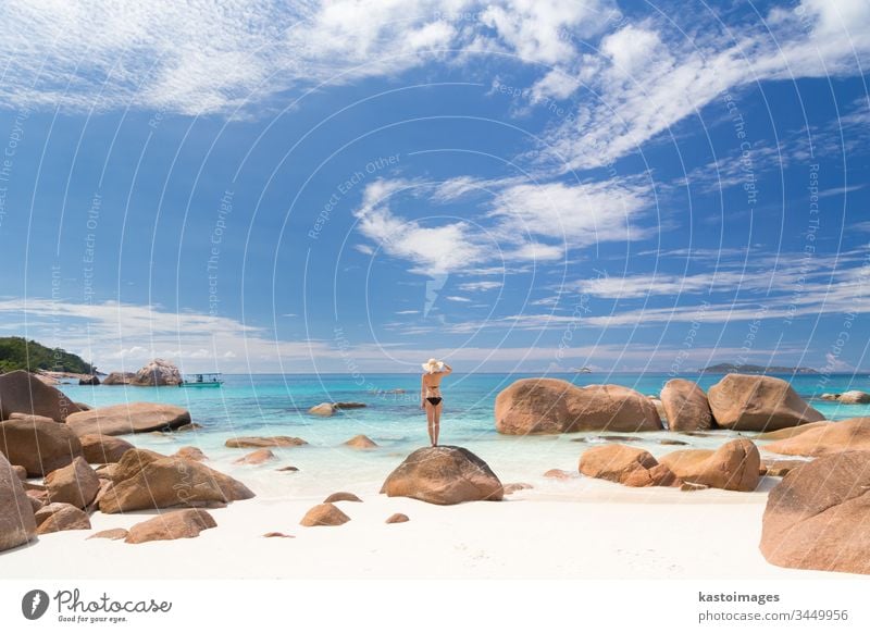 Woman enjoying Anse Lazio picture perfect beach on Praslin Island, Seychelles. travel summer vacation woman seychelles lifestyle holiday sea freedom sand island