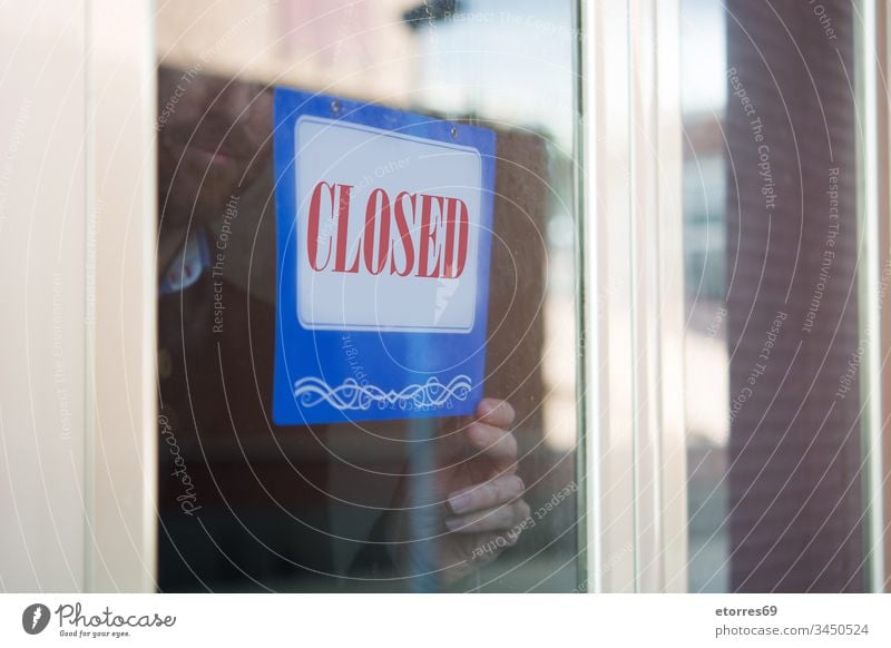 Business man hanging closed sign for coronavirus COVID-19 beard business man caution crisis door employee entrepreneur epidemic glass message notice owner