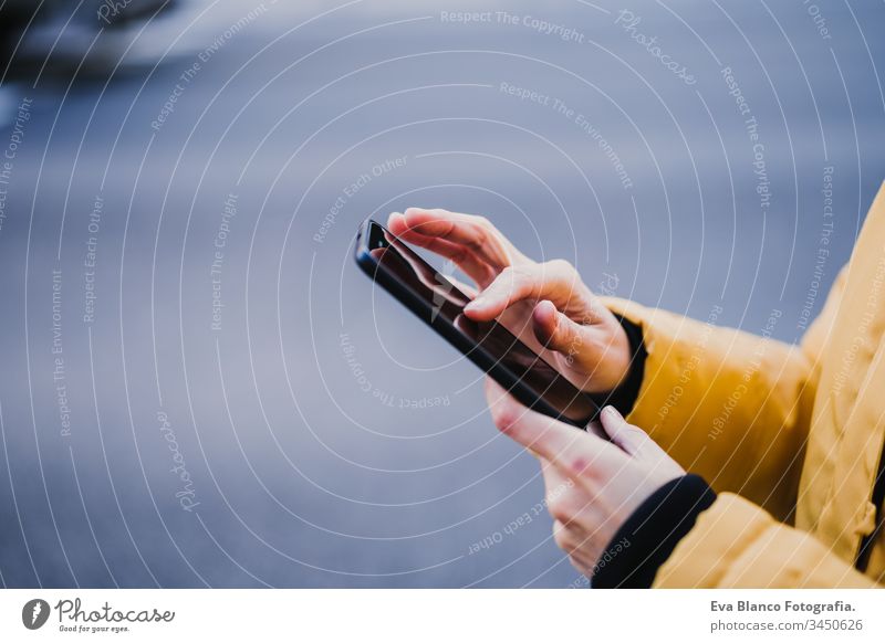 unrecognizable tourist woman using mobile phone outdoors in the street. lifestyle and travel concept technology city urban smile happy caucasian adult happiness