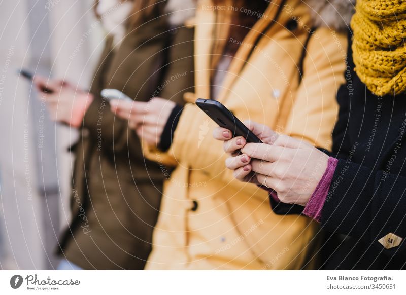 group of friends using mobile phone outdoors in the street. lifestyle and travel concept friendship tourist tourism three 3 technology city urban smile happy