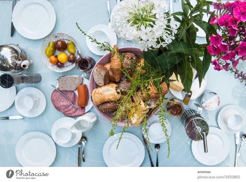 Set breakfast table Breakfast Table Crockery White flowers sausage Roll tomatoes Breakfast table covered Colour photo Food Plate Interior shot Baked goods