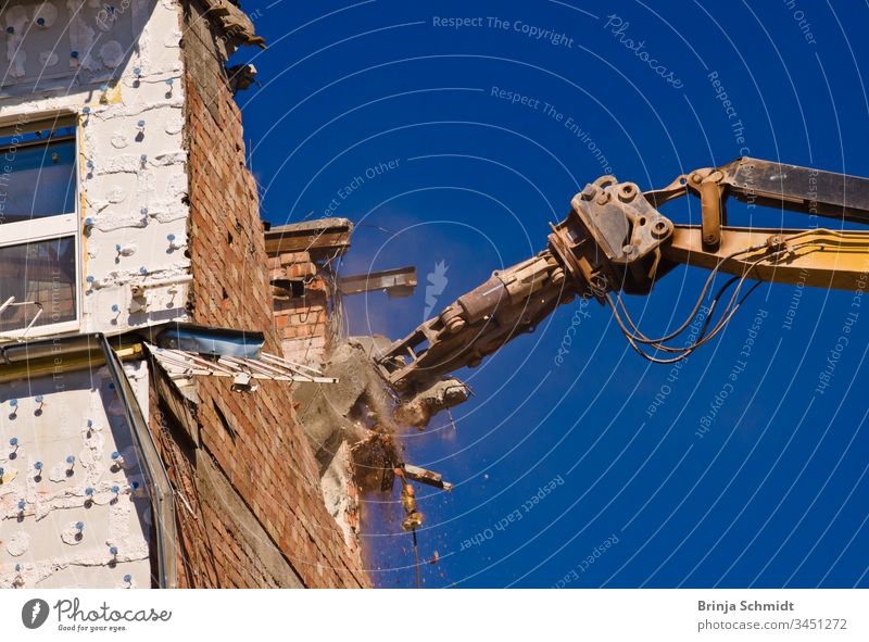 Demolition of a building with a crane against a blue sky Profession City Building owners Old House (Residential Structure) aborting Crush Exterior Architecture