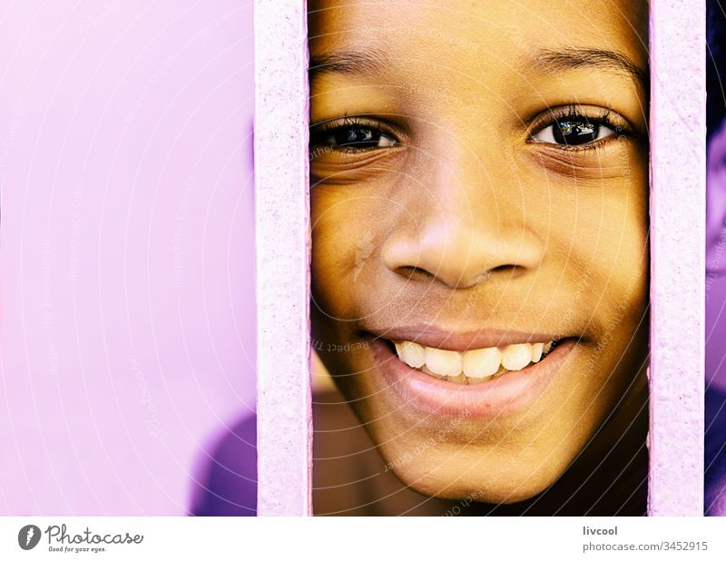 nice cuban boy III , santiago de cuba caribean island cuban man child yellow fence portrait handsome cute people street real people lifestyle smile kid children