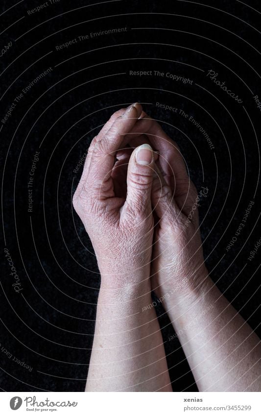 mature hands, washed too often, lying folded on black background, corona thoughts crease by hand Fingers Thumb fingernails Human being Skin Mature moody