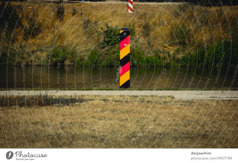 There are two border posts on the river bank. The one in front is for Germany, on the opposite side Poland. Nearby is the city of Görlitz. Exterior shot