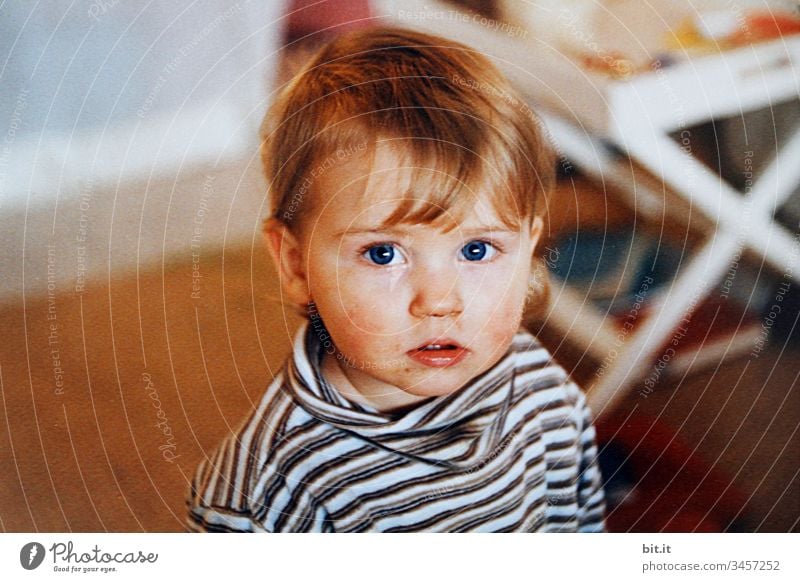 Little girl with a slightly smudged face, at home, looks curiously into the camera. Child Human being Toddler portrait Looking Infancy Forward