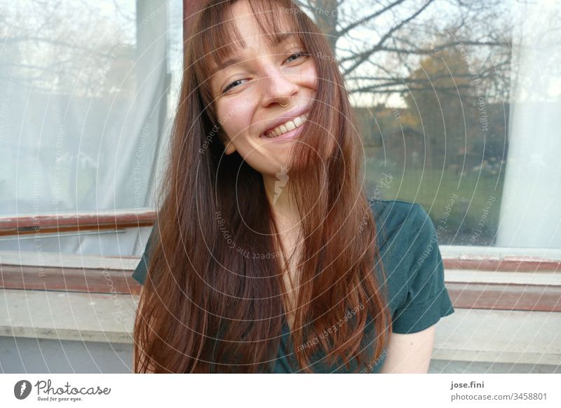 Laughing, the young woman looked into the camera, her long red hair and fringed fringe fell slightly on her face, the photographer snapped, and he couldn't take his eyes off her.