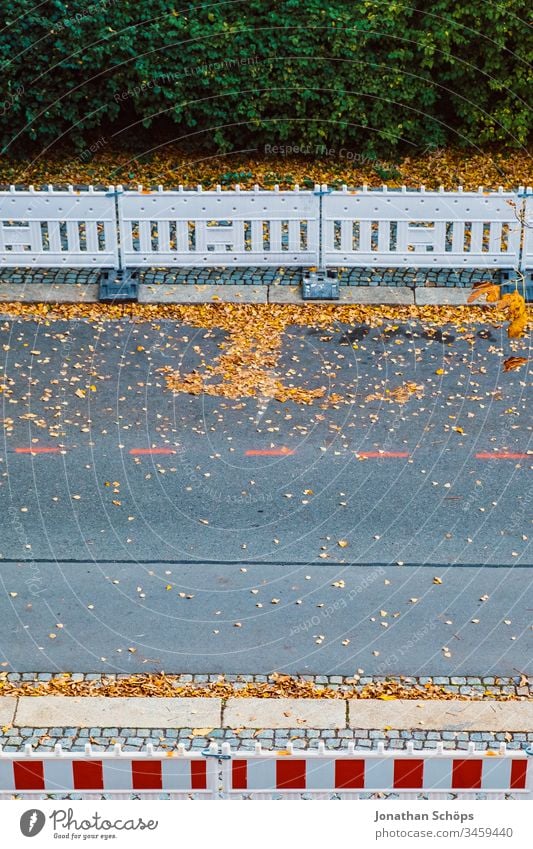 Top view on street in autumn with roadwork safety fence Autumn Minimalism Park Street Urban asphalt background image barrier bird's eye view construction