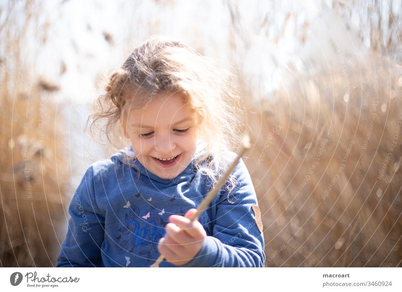 Child playing in the reeds by the lake plays Lake Exterior shot Nature Colour photo Landscape Water spring Lakeside Deserted covid19 school closures Free