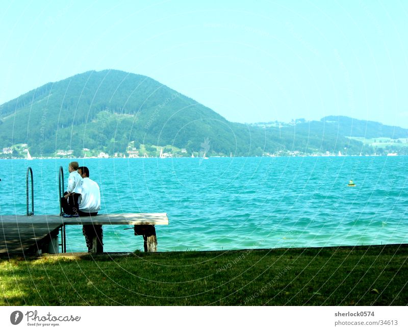 Peace at the lake Lake Father Son Calm Footbridge Meadow Water Mountain Far-off places