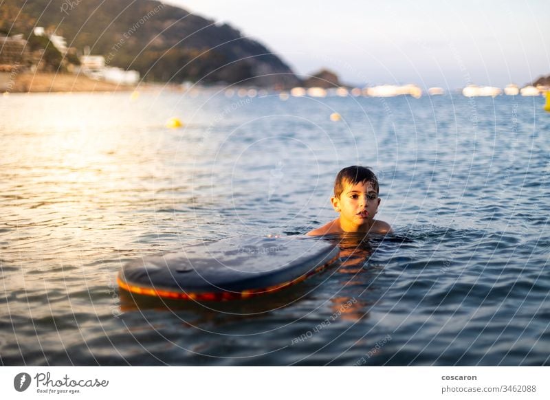 Little child with a bodysurf on the sea active activity beach beautiful beauty blue board boarding bodyboard bodyboarding bodysurfing cheerful childhood coast