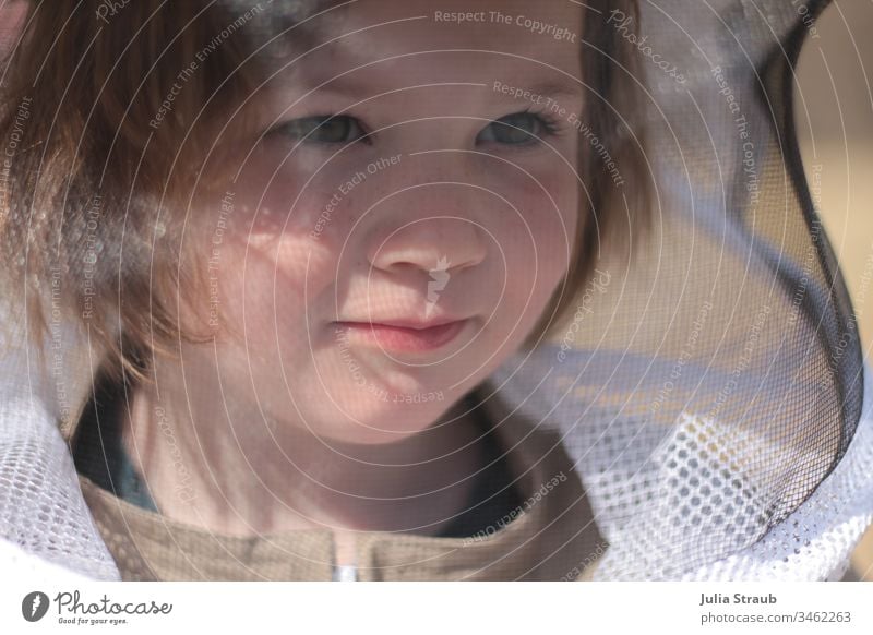 Girl with sceptical look in beekeeper suit Freckles fringe hairstyle Veil Protective clothing Skeptical Bee-keeping keep beekeepers Portrait photograph