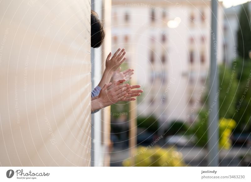 People clapping in the window in support of people who fight against the coronavirus epidemic balcony woman girl health building global you infection house