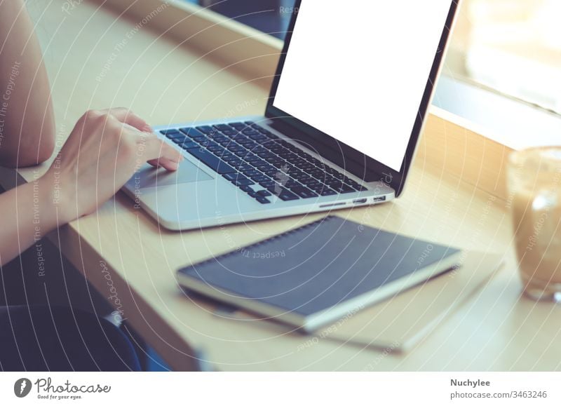 Close up of young businesswoman typing on computer laptop with blank screen at the office or cafe asian background blogger browsing casual cheerful closeup