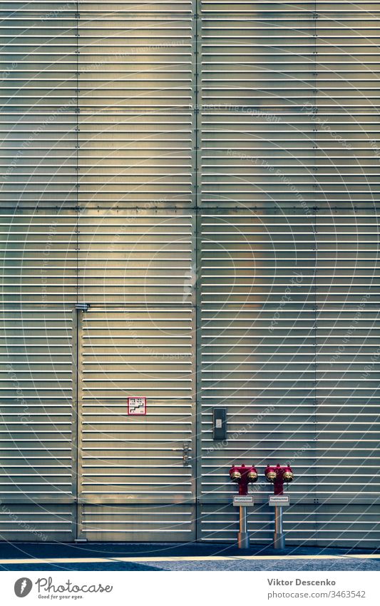 Fire hydrants at the corrugated wall and door background design abstract water pattern texture construction steel iron security metal urban building gray fire