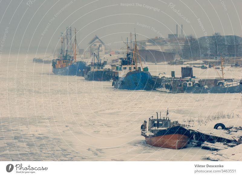 Fishing boats in the ice of a frozen bay baltic beach blue business cargo city coast cold commercial covered december europe european february fishing freight