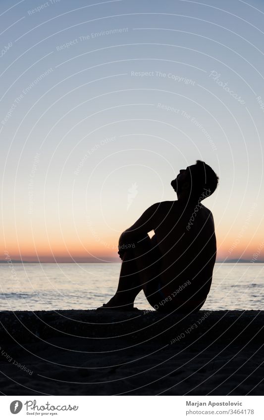 Silhouette of a man by the sea in sunset adult alone anxiety beach beautiful bipolar coast depressed depression disappointed disorder evening feelings horizon