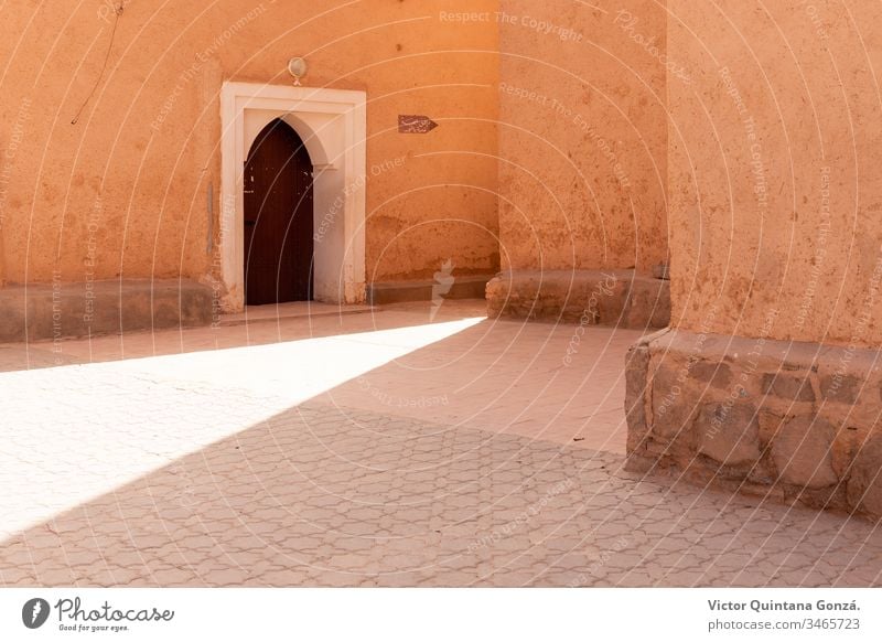 Moroccan street with sunbeam African Berber Marrakech Morocco adobe africa ancient antique arch architecture art building courtyard door no person old outdoors