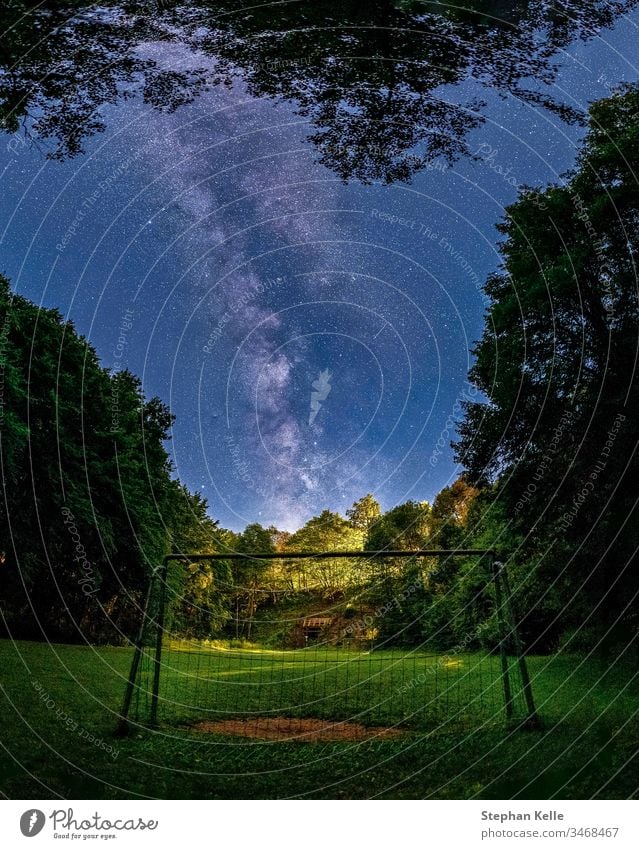 The Galactic Center of the Milky Way in the sky above the goal of a soccer field excluded. Milky way Goal Playground Room starlit Astrophotography background