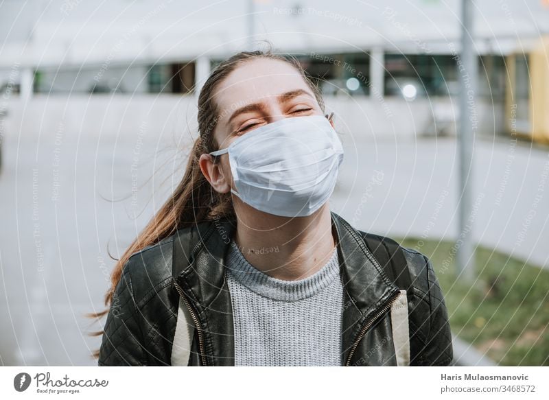 Young woman enjoy the sun with mask for protection from coronavirus covid-19 air air mask blonde caucasian corona epidemic corona italy corona virus dark end