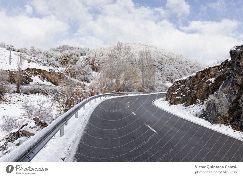 curved road in snowy landscape cold drive europe fog frost frosty frozen guidance ice lane mountain nature palencia route sky slippery snowstorm spain