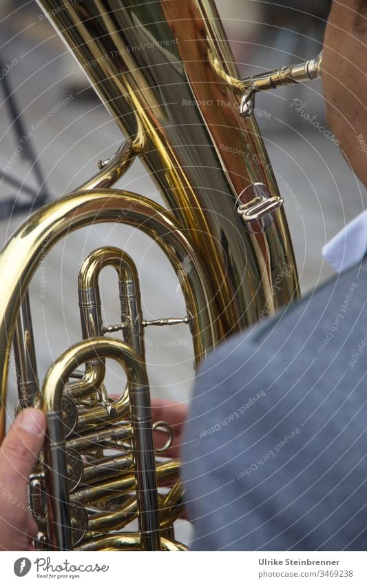 Detail of a tenor horn in Allgäu brass band Brass instrument Brass band Music Chapel Tuba player Musician Tin golden valves Fingers Folklore music Indian ink