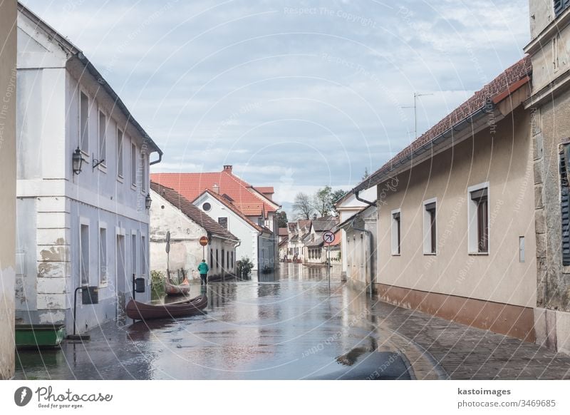 Flooded street flood river water village town house global worming rural home weather rain environment natural danger road wet damage building insurance risk