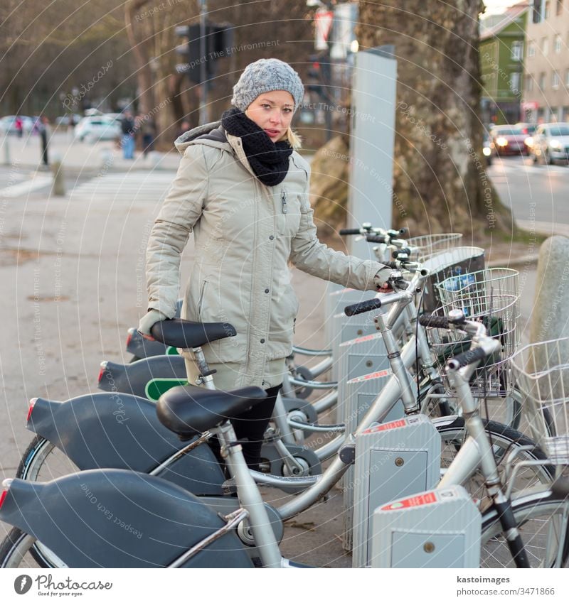 Station of urban bicycles for rent. woman public transport keyboard station transportation citibike dialpad city rental environment row lifestyle hire wheel