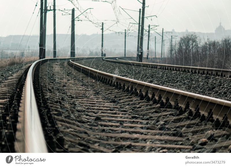 old railroad rails and poles with wires background day deserted desolate diraction. steel elevated gloomy industry iron landscape line metal nature no people