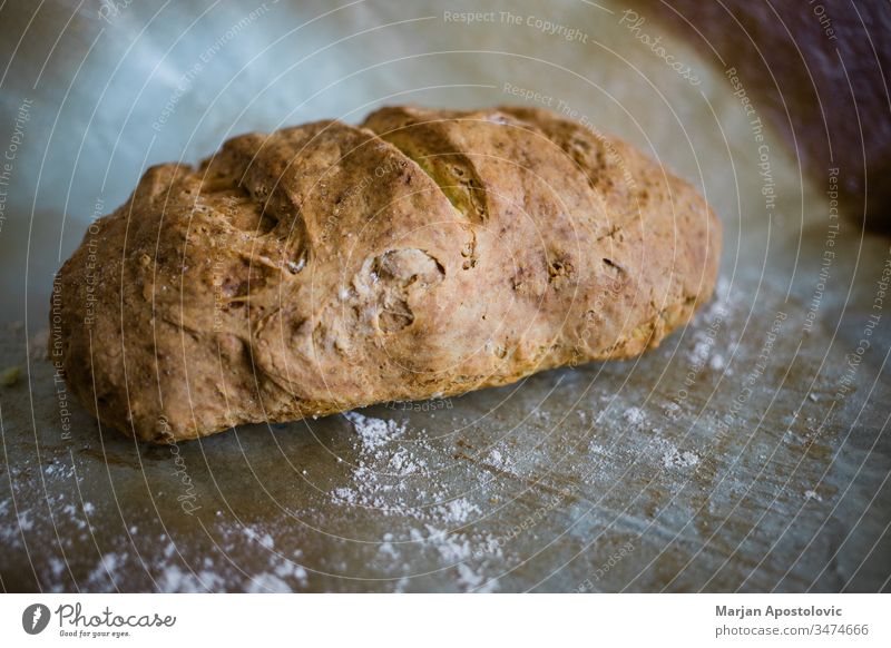 Close-up of a fresh homemade bread on baking paper above bake bakery breakfast brown bun close-up closeup countryside crust cuisine delicious diet dinner eat