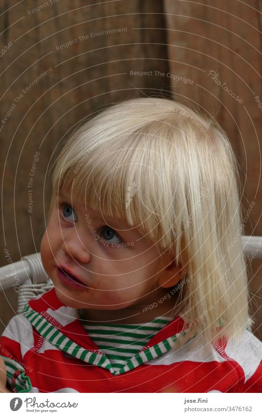 Little girl sitting on a chair looking up portrait Child little girl big eyes natural Brash Cute Parenting observantly listen understand Spellbound Impish