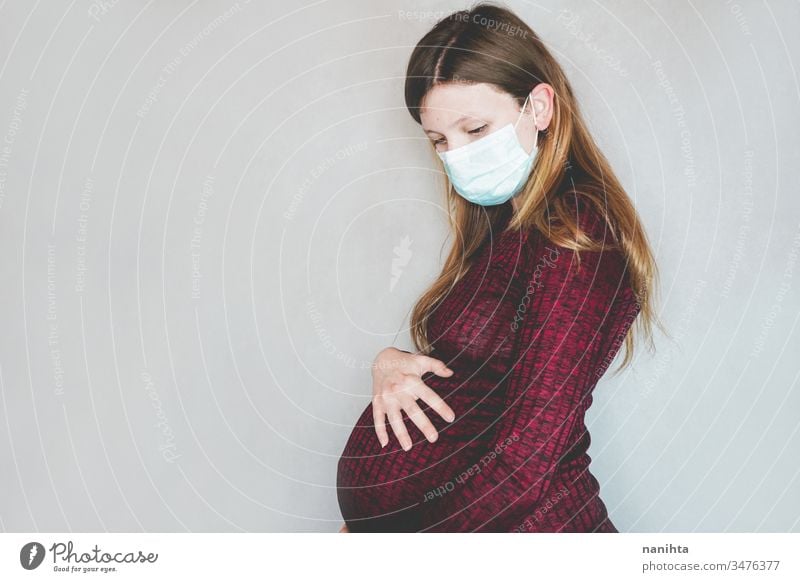 Young pregnant woman wearing a face mask covid 19 flu influenza coronavirus pandemic epidemic illness pregnancy risk group respiratory illness social distance