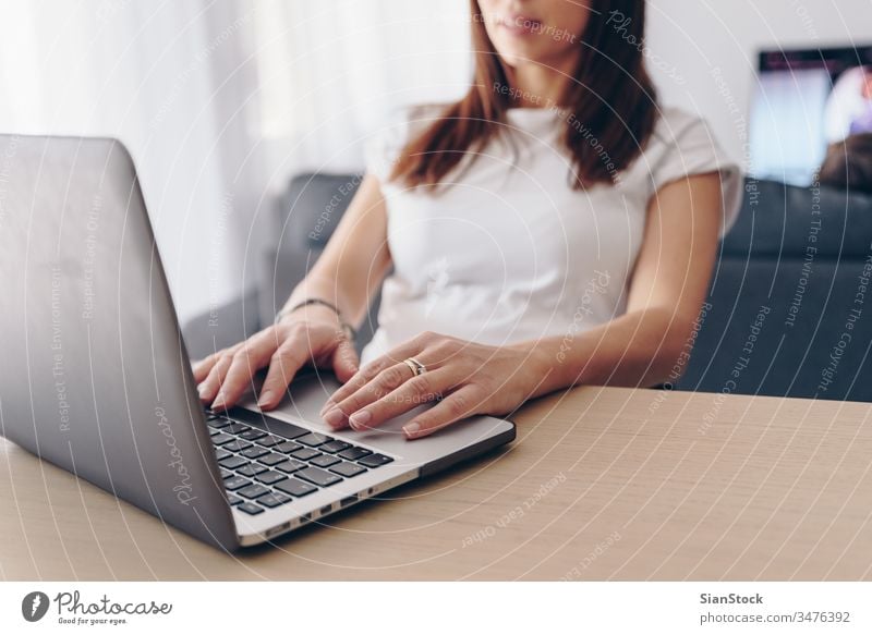 Young woman working from home computer laptop office desk using young business female internet technology person tv child businesswoman sitting freelance