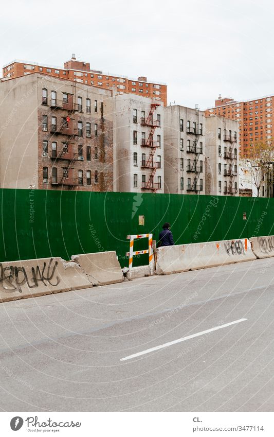 residential buildings in harlem, new york Street person Human being Going houses Decline Gloomy Wall (building) Construction site High-rise Apartment Building