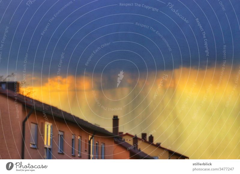 Rain wall in the sky behind house in the evening Sky Weather houses Light Evening