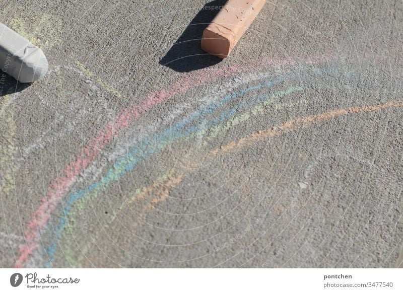 Rainbow painted with street chalk and two street chalk Street chalks Painting (action, artwork) Children's game Joy Creativity corona symbolism out Pastime