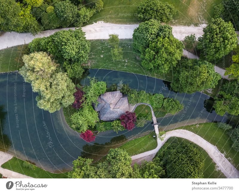 Aerial view over a park, canal with coloRed trees. above aerial travel top landscape green forest drone water vertical tourism wonderful Munich summer river