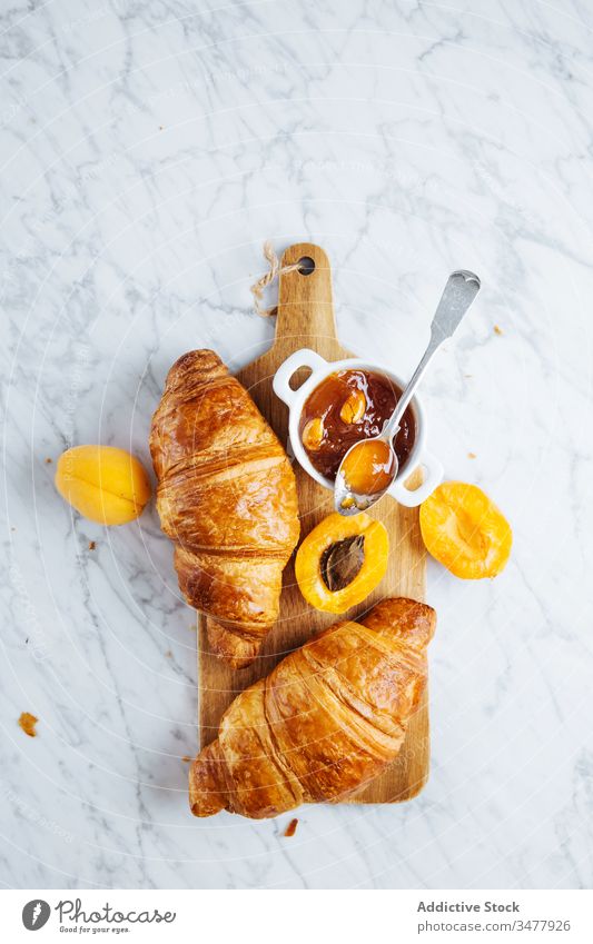 Croissant and apricot jam on wooden board croissant pastry breakfast bake fresh natural morning food serve delicious tasty meal tradition gourmet nutrition