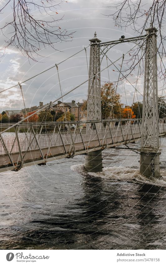 Bridge over river in autumn day bridge suspension footbridge old scotland city overcast architecture construction cloudy travel tourism water structure path way