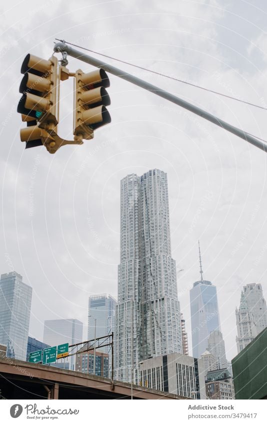 Traffic light in modern downtown city traffic skyscraper building contemporary urban cityscape street metropolis new york district architecture cloudy usa