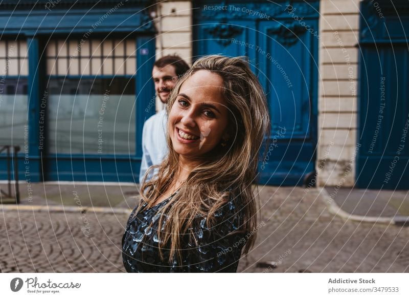 Joyful young couple walking on street city happy together building old cheerful smile follow travel holiday casual romantic love relationship lifestyle urban