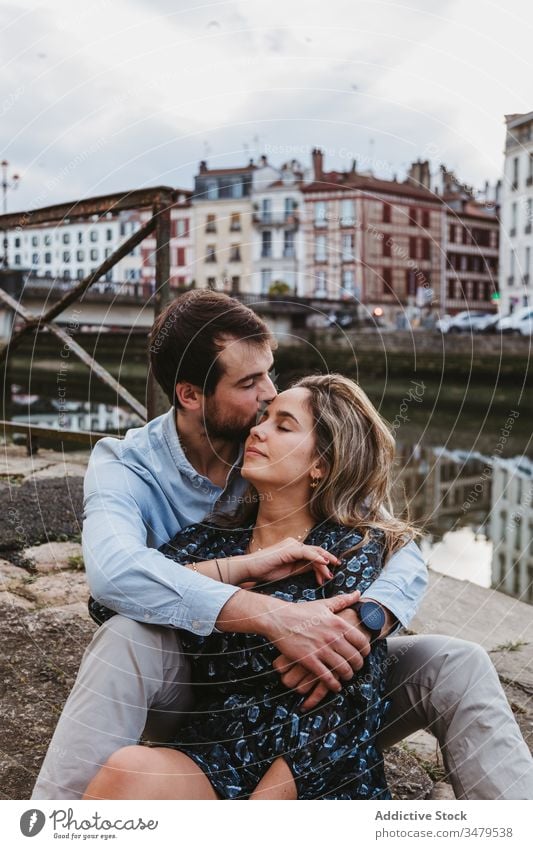 Affectionate couple resting on street embrace happy love enjoy city historic together relationship travel romantic boyfriend girlfriend hug date affection