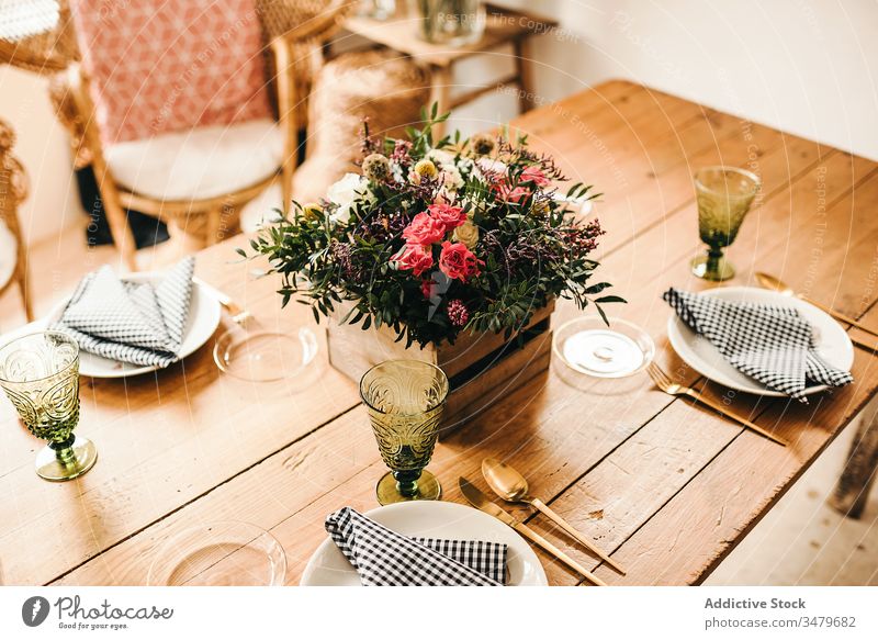 Flowers and plant twigs on a box decorating a wooden table flowers bunch leaf bouquet petal concept glass fresh bloom interior vintage nature decorative