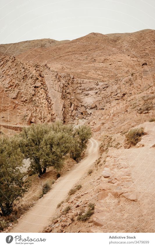 Desert landscape of mountainous terrain with road desert dry valley countryside nature africa morocco travel tourism empty curve route sand scenery hill way hot