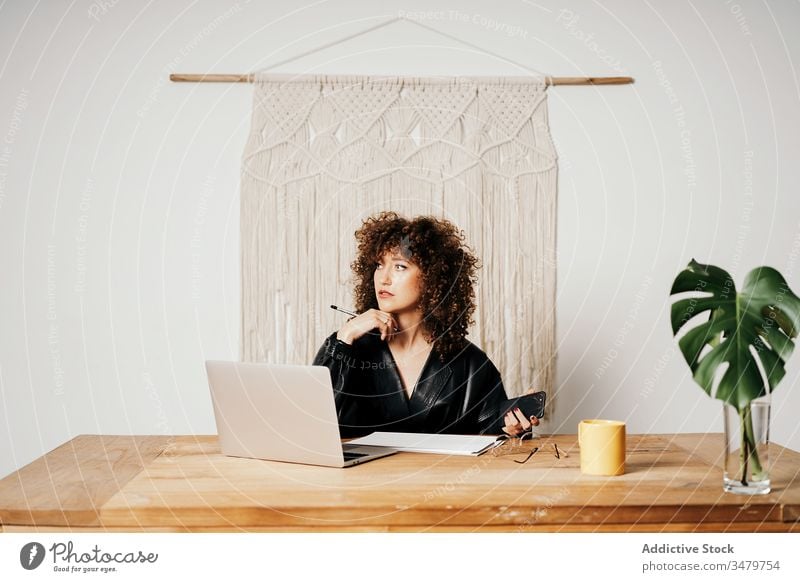 Retro businesswoman working in office laptop data read retro table leather sit project female vintage curly hair job gadget jacket device workplace professional