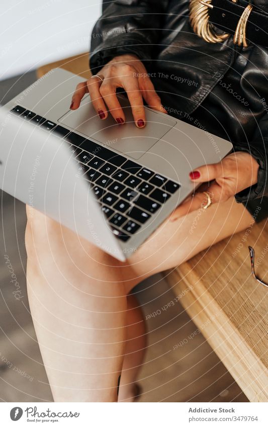 Vintage businesswoman using laptop on table office work leather jacket sit retro style outfit female cool project startup 80s fashion device gadget browsing