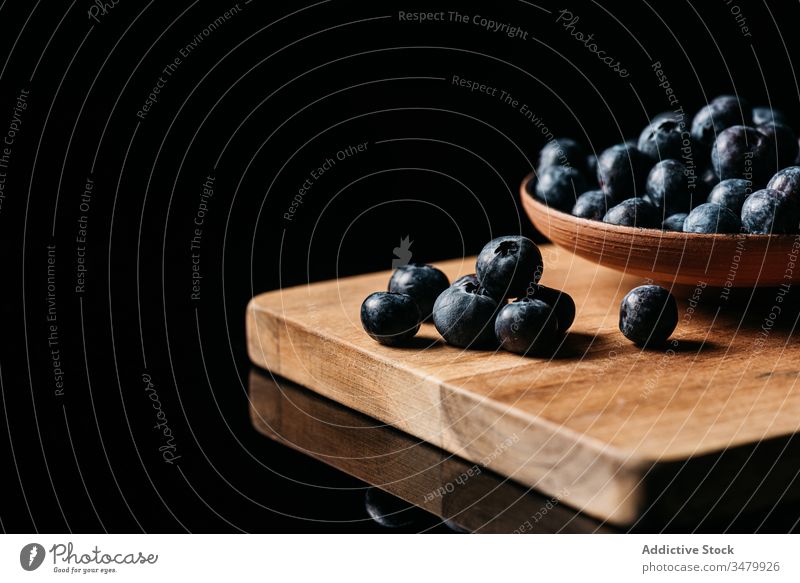 Fresh blueberries on wooden table blueberry dark food fresh bowl natural ripe delicious tasty ingredient healthy nutrition vegetarian vitamin raw meal yummy